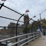 volunteer placing flags on bridge