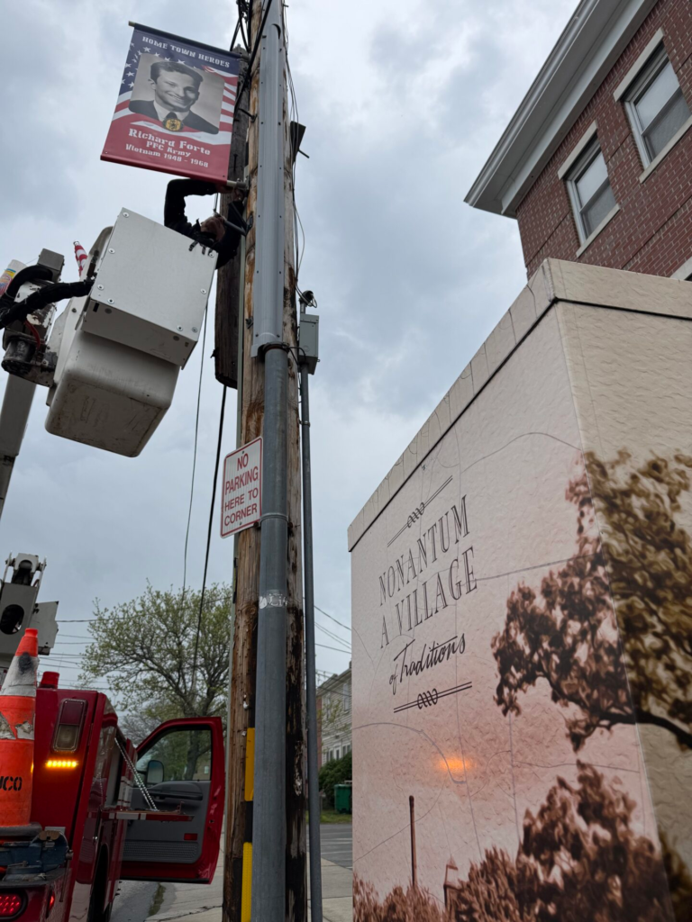 bucket truck installing pole banner