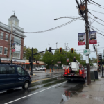 bucket truck installing pole banner