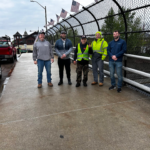Group placing flags on bridge